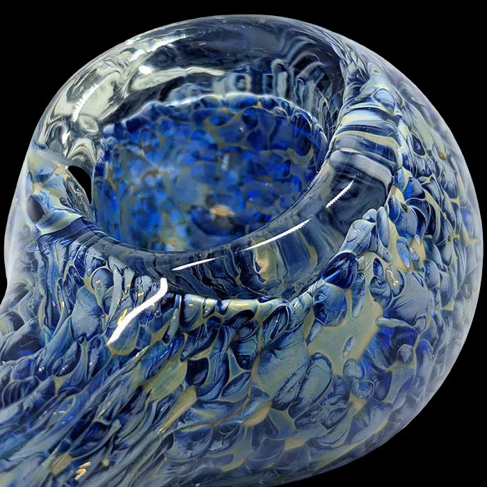 Blue and white glass bowl with marbled pattern on a white background