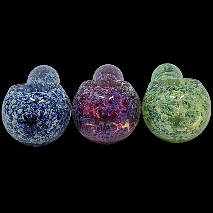 Three colorful glass containers with textured surfaces on a white background